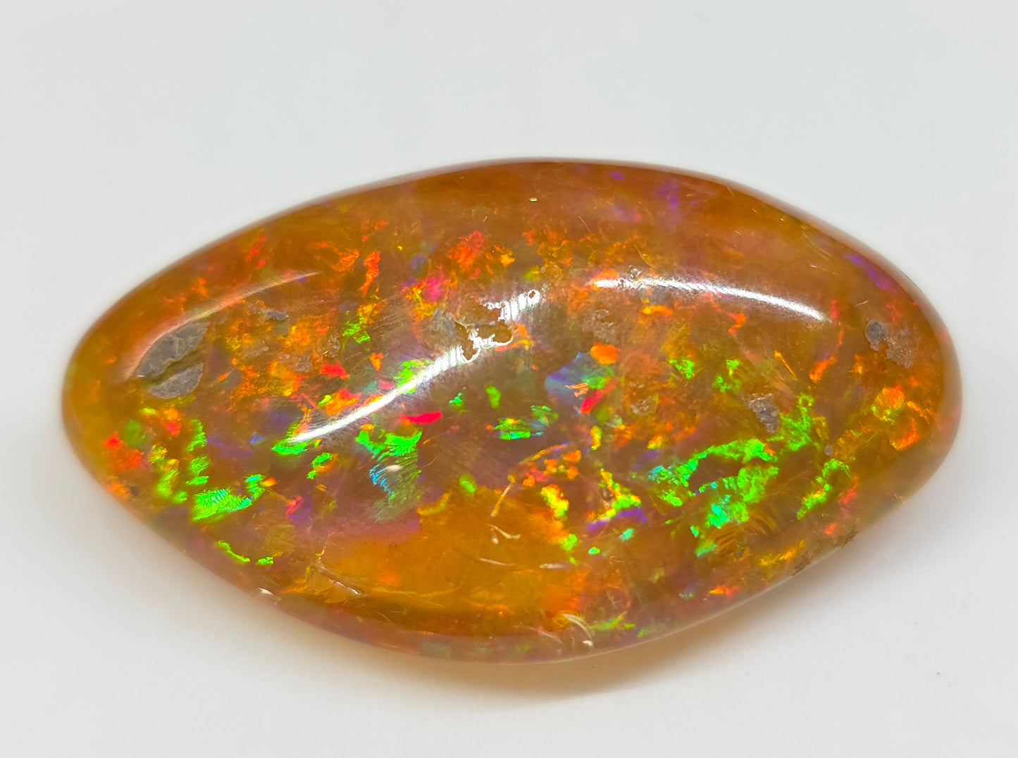 Multicolored opal stone on a white background