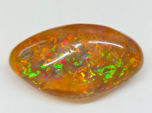 Multicolored opal stone on a white background
