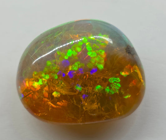Multicolored opal stone on a white background