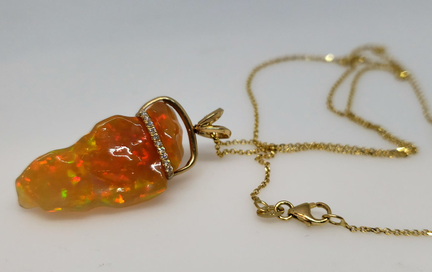 Carved orange opal spinning pendant #101