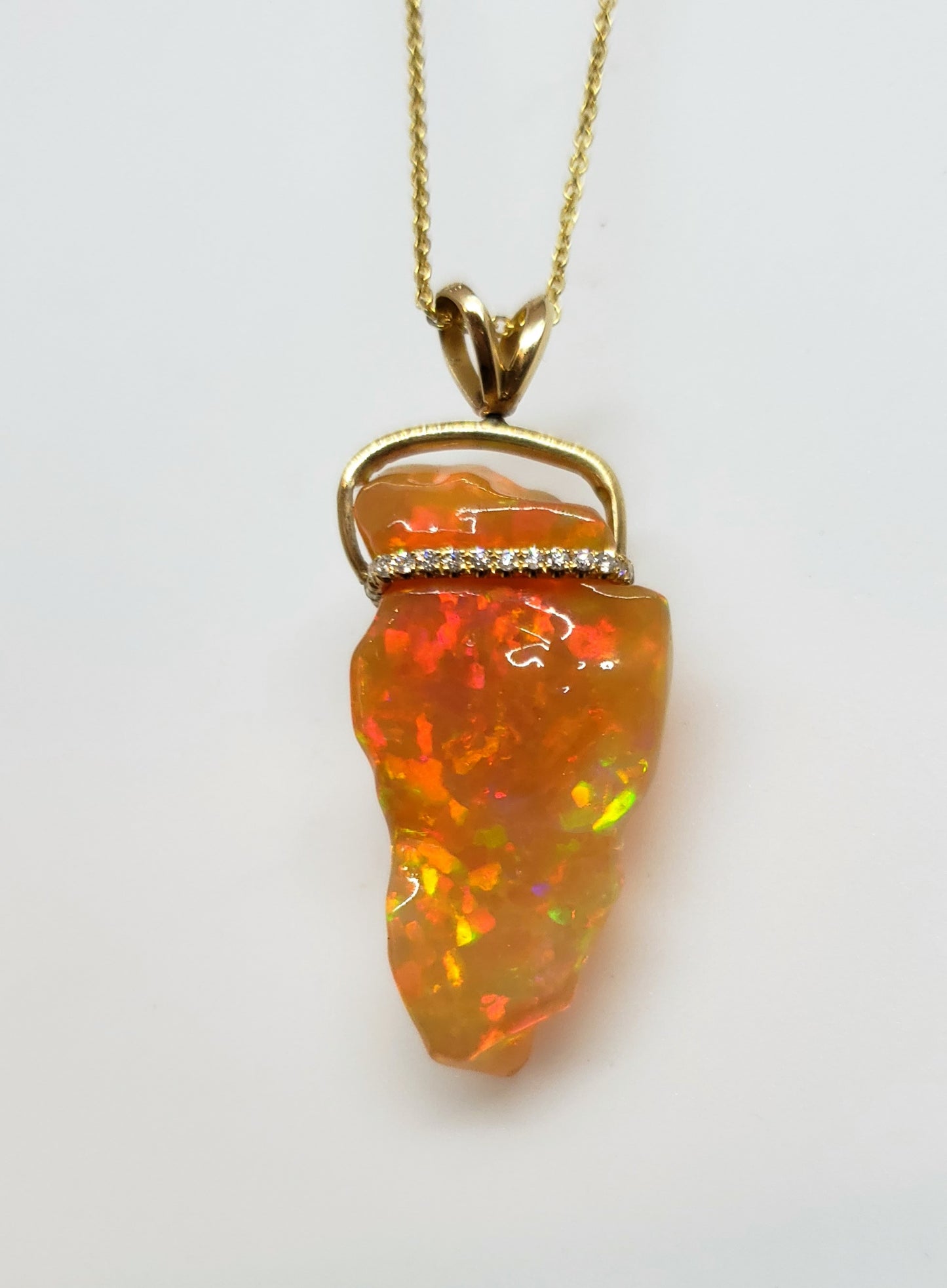 Carved orange opal spinning pendant #101